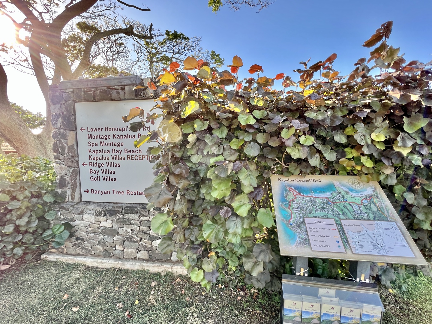 Lahaina Vacation Rentals, Kapalua Ridge 2321 - This image captures the entrance signage to a scenic golf course and resort area, surrounded by lush foliage