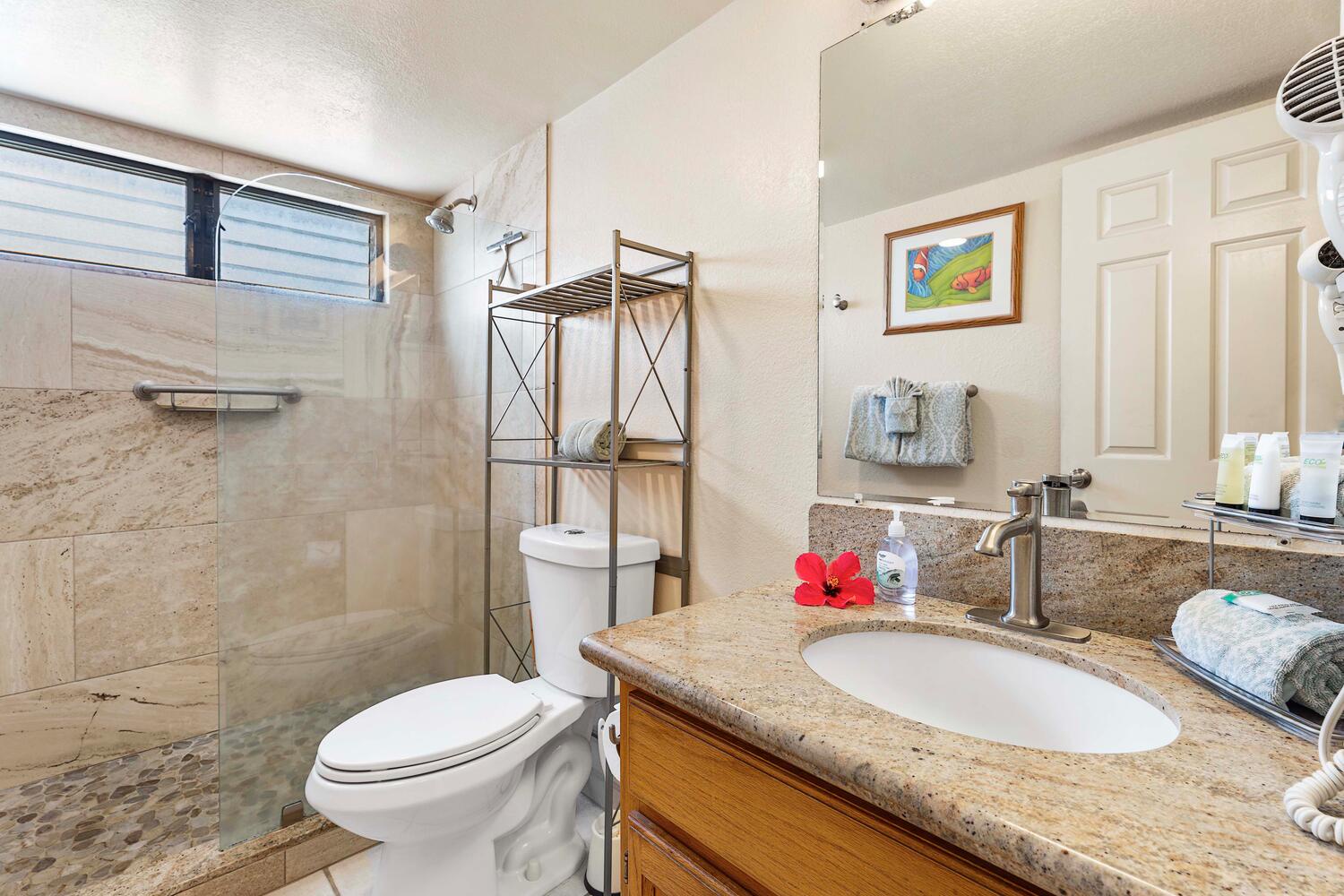 Kailua Kona Vacation Rentals, Kona Reef F11 - The full Bathroom has Granite Counter and a Glass Step-in Shower with River-Rock base.