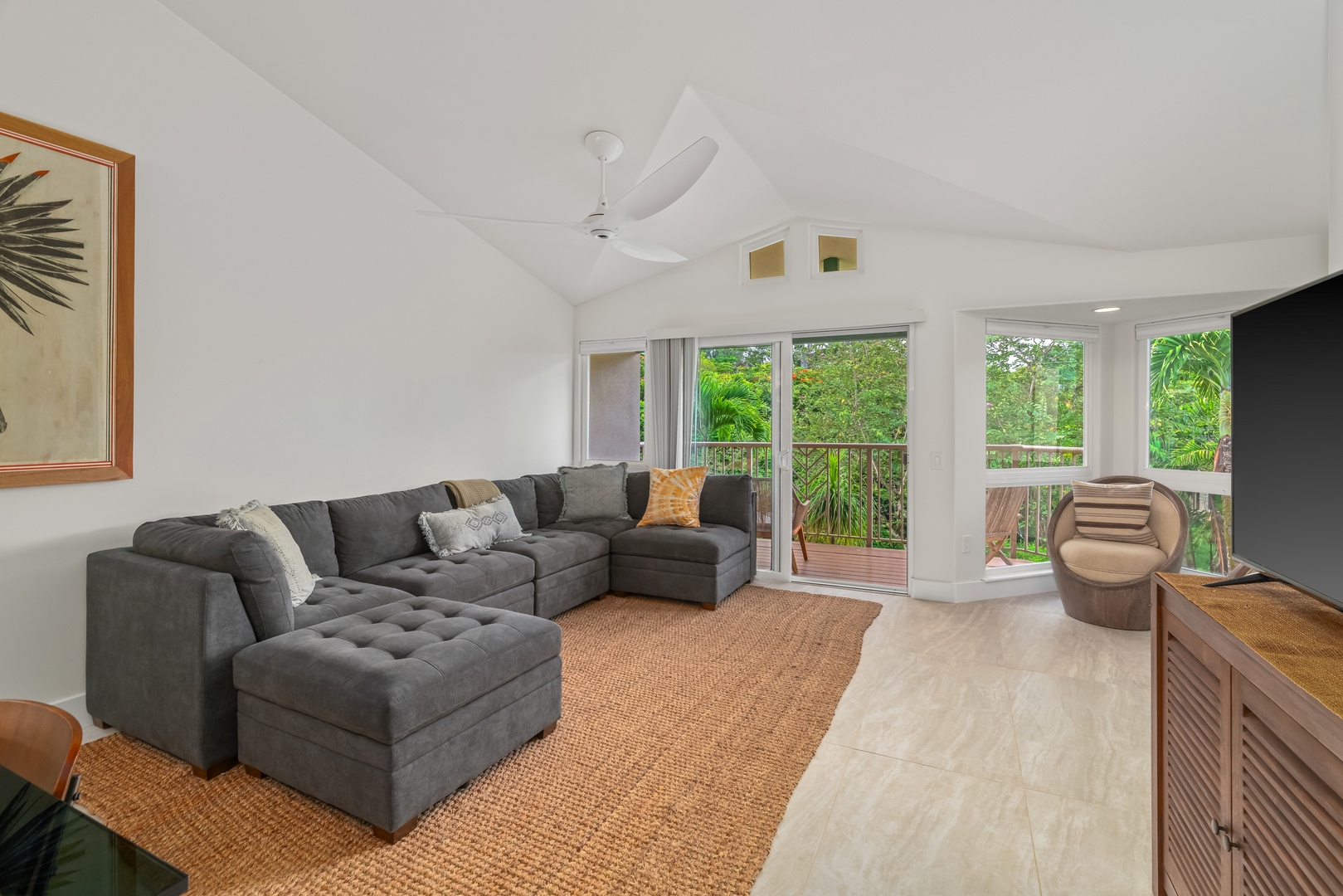 Princeville Vacation Rentals, Mana Wahine - Spacious living room with vaulted ceilings and views of the lush Kauai greenery.