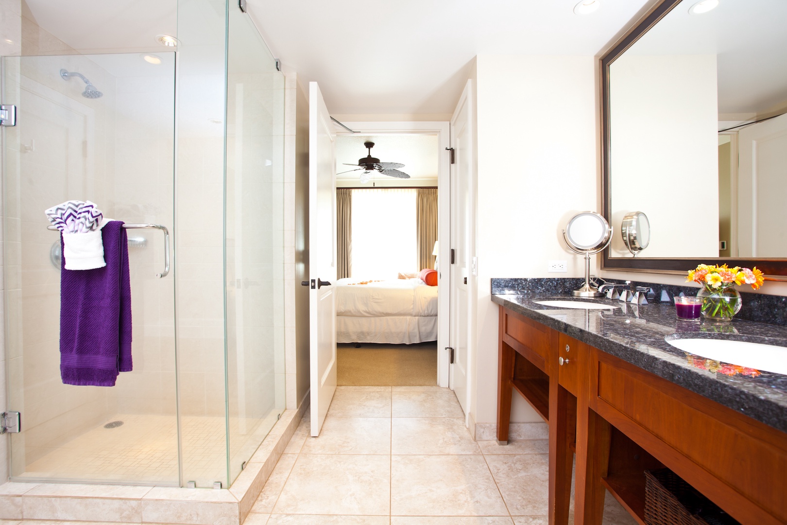 Lahaina Vacation Rentals, Honua Kai Hokulani 214 - A sleek and modern bathroom leads directly to a cozy bedroom, the glass-enclosed shower and stylish vanity add a touch of luxury to your daily routine