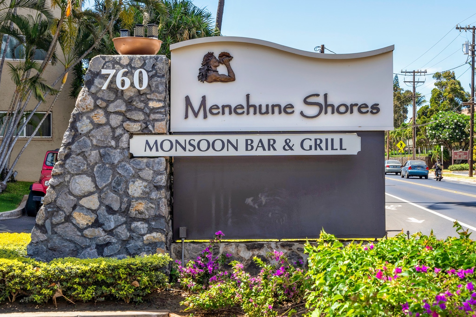 Kihei Vacation Rentals, Menehune Shores 316 - The building's own sign points to Monsoon Bar & Grill, dinner without ever leaving the property.