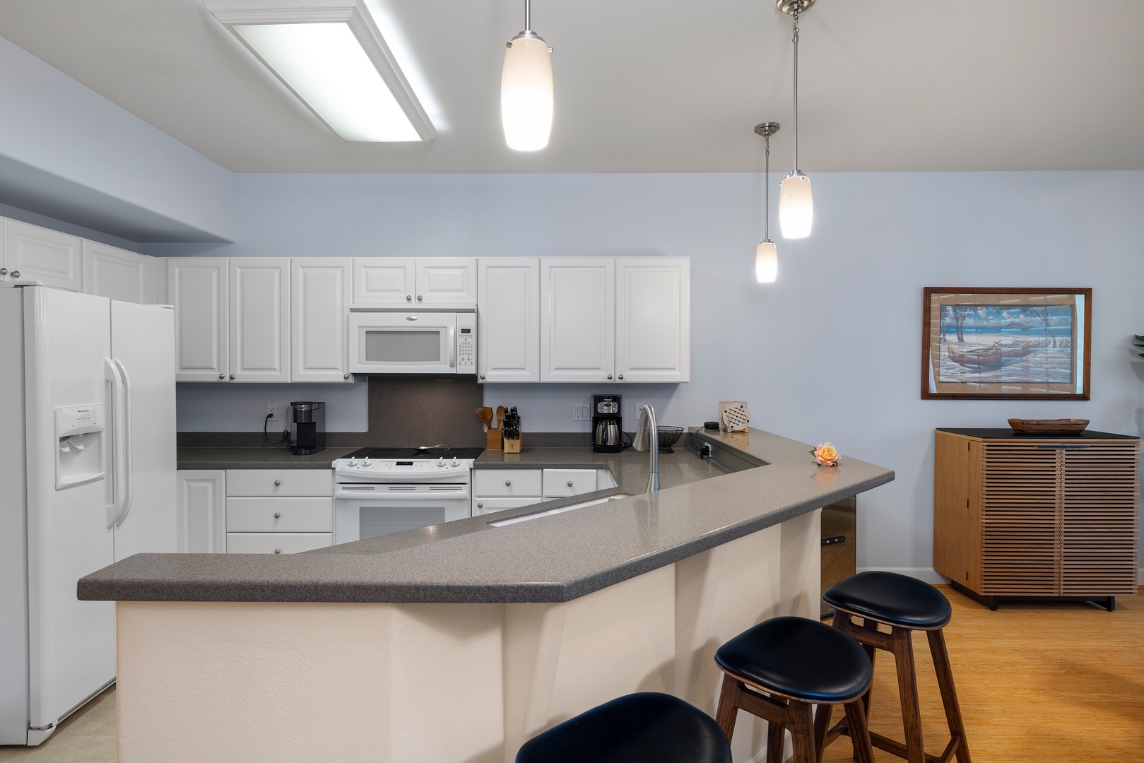 Your fully equipped kitchen awaits with sleek countertops, modern appliances, and a breakfast bar perfect for morning coffee or casual meals.