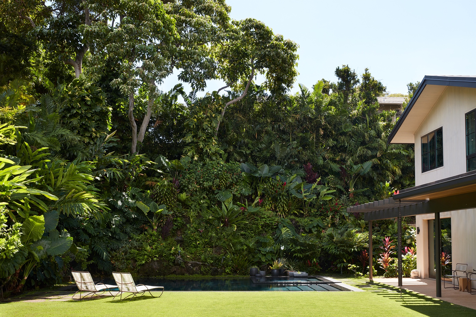 Honolulu Vacation Rentals, Diamond Head Hillside Estate** - Expansive lawns and tropical plantings provide a serene backdrop for outdoor gatherings, recreation, and quiet moments in the sunshine.