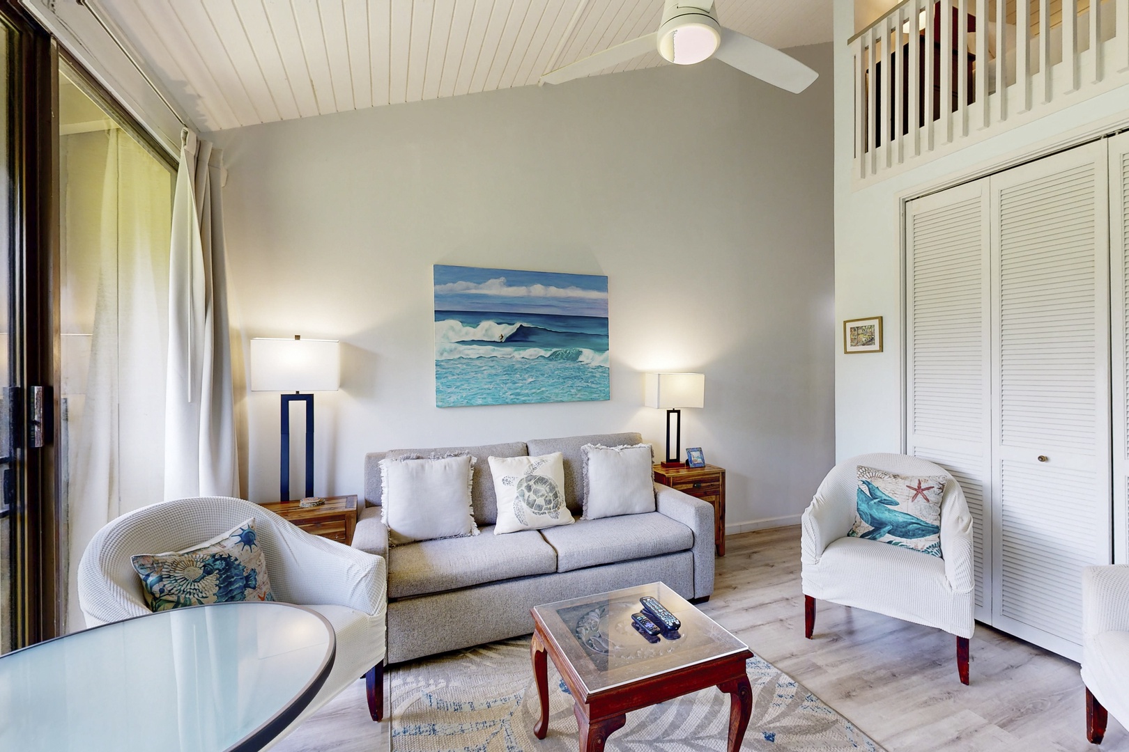 Kahuku Vacation Rentals, Kuilima Estates West #132 - Comfortable seating area with natural light and ceiling fan.