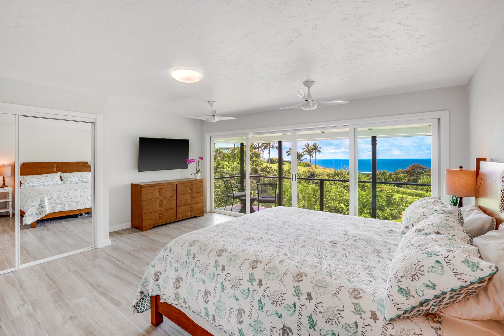 Princeville Vacation Rentals, Wai Lani - Guest Room 2 with TV, a private lanai, and panoramic views.