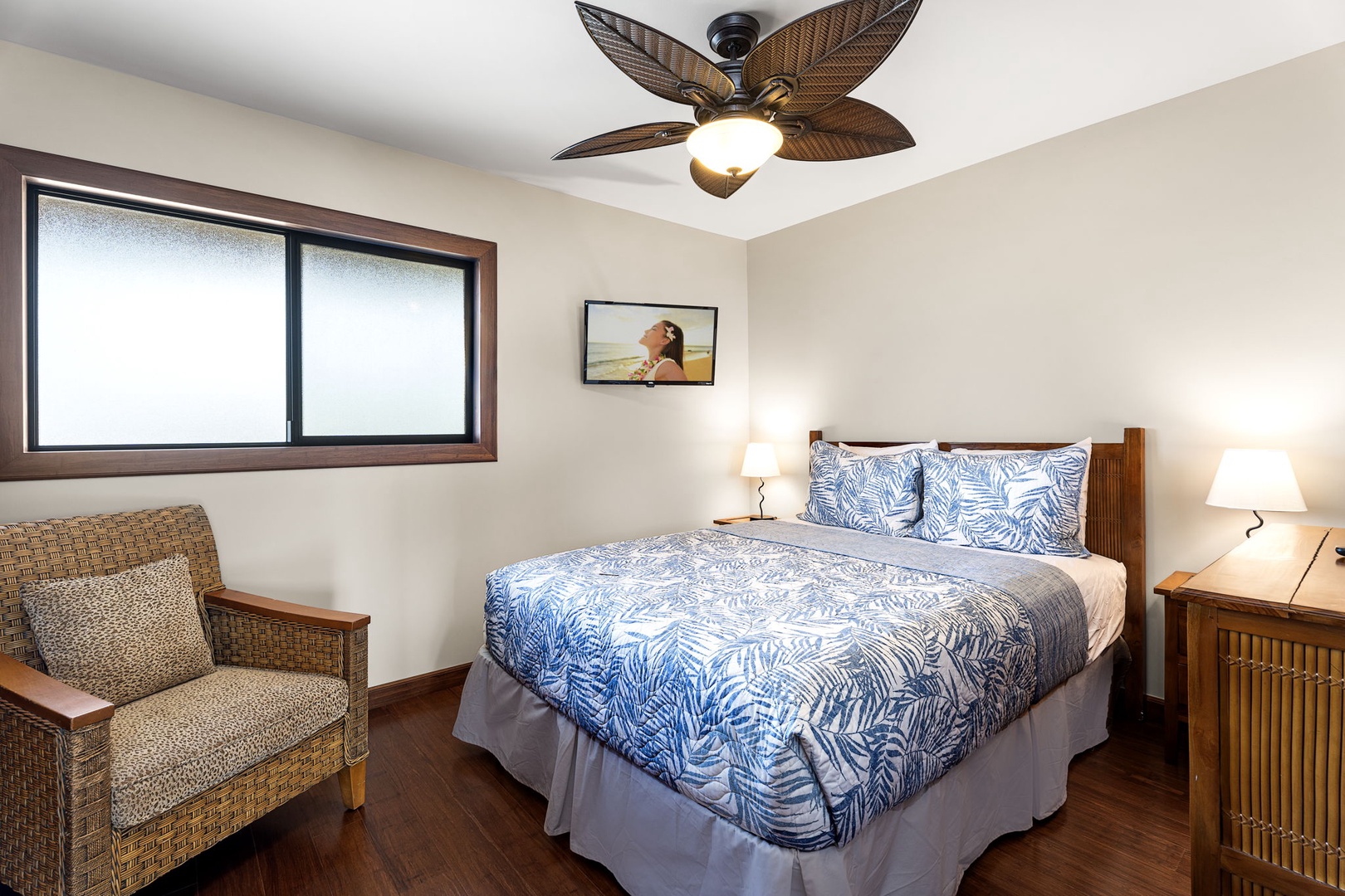 Kailua Kona Vacation Rentals, Royal Kahili 401A - Bright bedroom with a queen-sized bed, cozy seating area, and natural light.