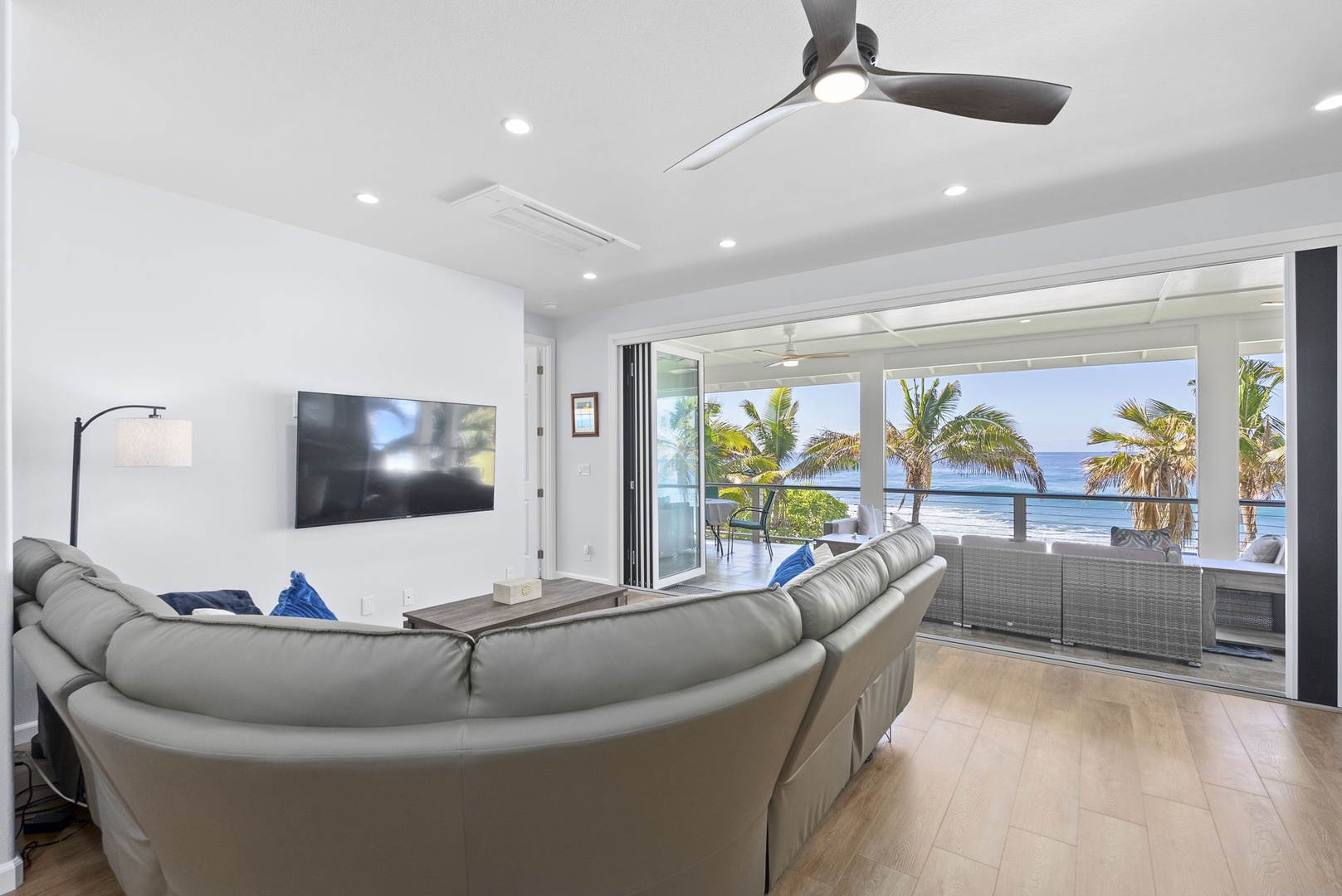 Waianae Vacation Rentals, Oceanfront Luxury Dream Estate - Second-story living area with TV, ceiling fan, and wall-to-wall windows overlooking the sea.