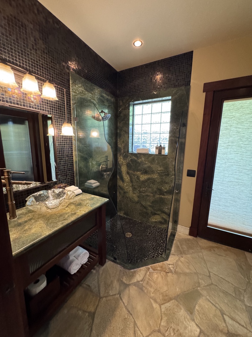 Kamuela Vacation Rentals, Hale Konane - Luxe ensuite bathroom with a sleek walk-in shower and stone finishes.