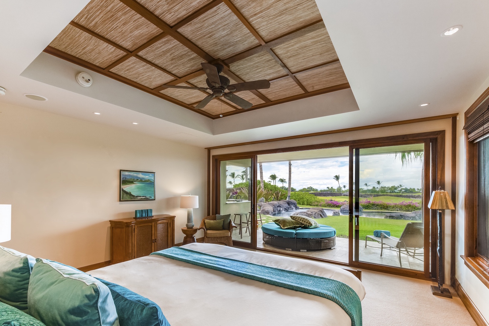 Kamuela Vacation Rentals, 3BD Ke Kailani (1C) at Mauna Lani Resort - Downstairs Primary Bedroom w/ Electronic Pocket Doors Open to Separate Lanai and Pool Area.