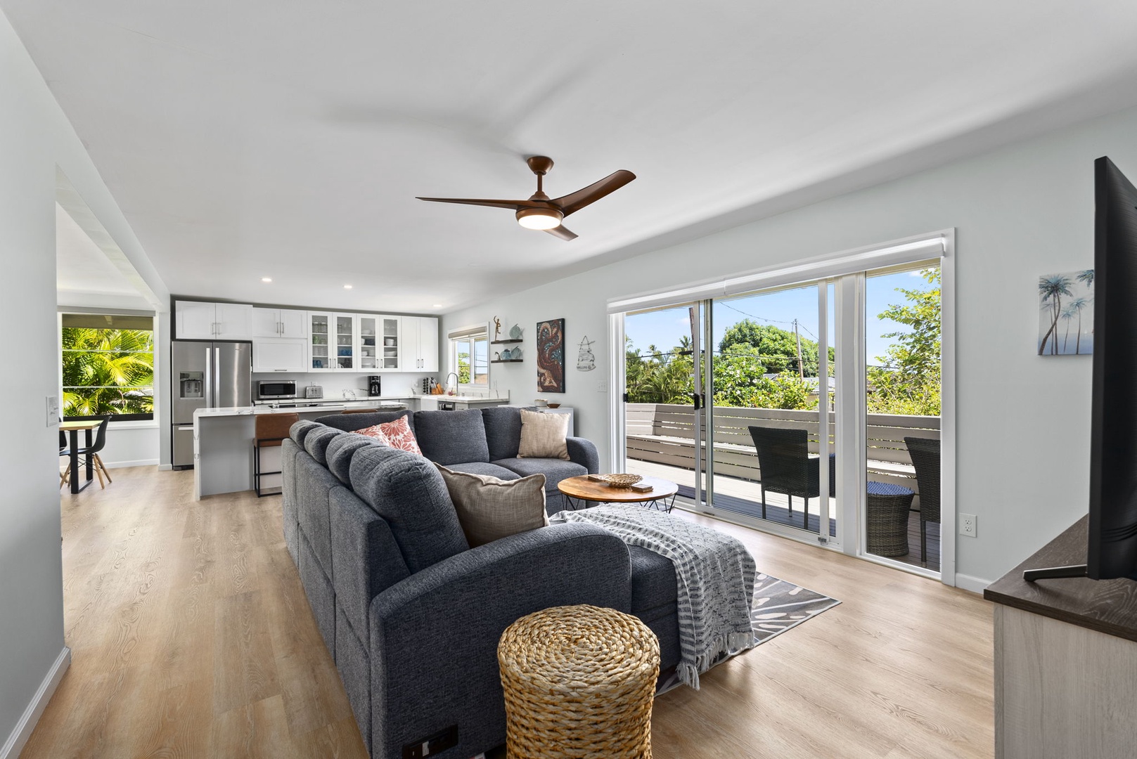 Kailua Vacation Rentals, Hale Alapi'i Lanikai Getaway - Enjoy the blend of comfort and style in this open living area, featuring a plush sofa and natural light flowing in from the sliding doors that lead to the outdoor lanai.