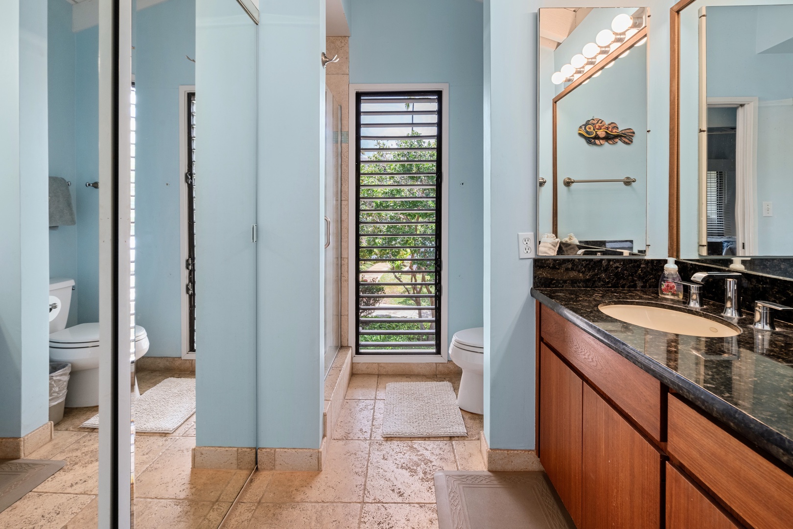 Kihei Vacation Rentals, Wailea Ekolu 204 - A colorful carved fish hangs above the granite vanity, easily the most personal touch in an otherwise spa-quiet bath.