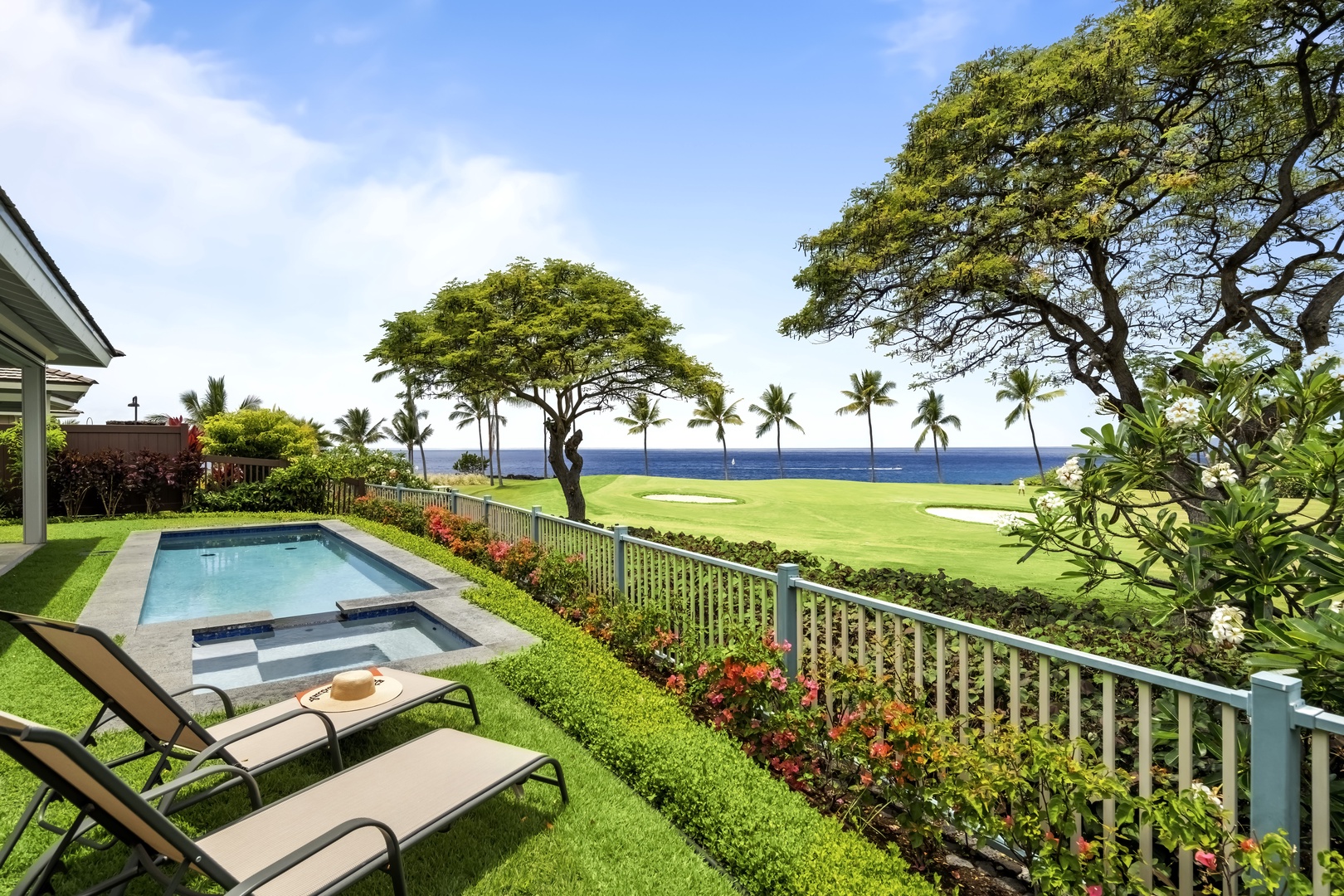 Kailua Kona Vacation Rentals, Holua Kai #27 - Two loungers on the grass, the fairway beyond the fence, and an afternoon with nowhere to be.