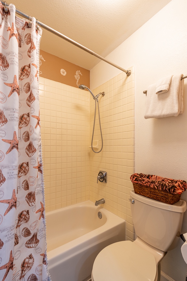 Kapolei Vacation Rentals, Fairways at Ko Olina 8G - Refresh in your private bathroom with coastal charm - sea-themed curtains and warm tiles create a relaxing seaside retreat.