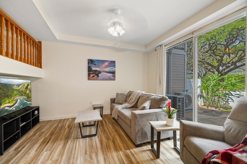 Relax in your bright living space with tropical garden views through sliding doors onto your private patio.