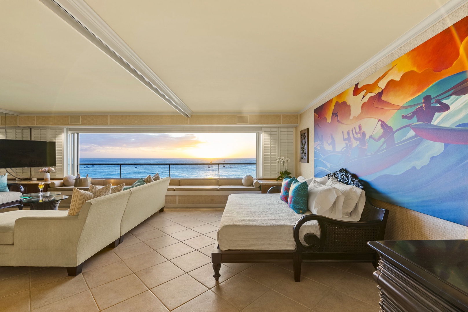 Honolulu Vacation Rentals, Hale Kaimana - Seating area with vibrant artwork and golden hour views.