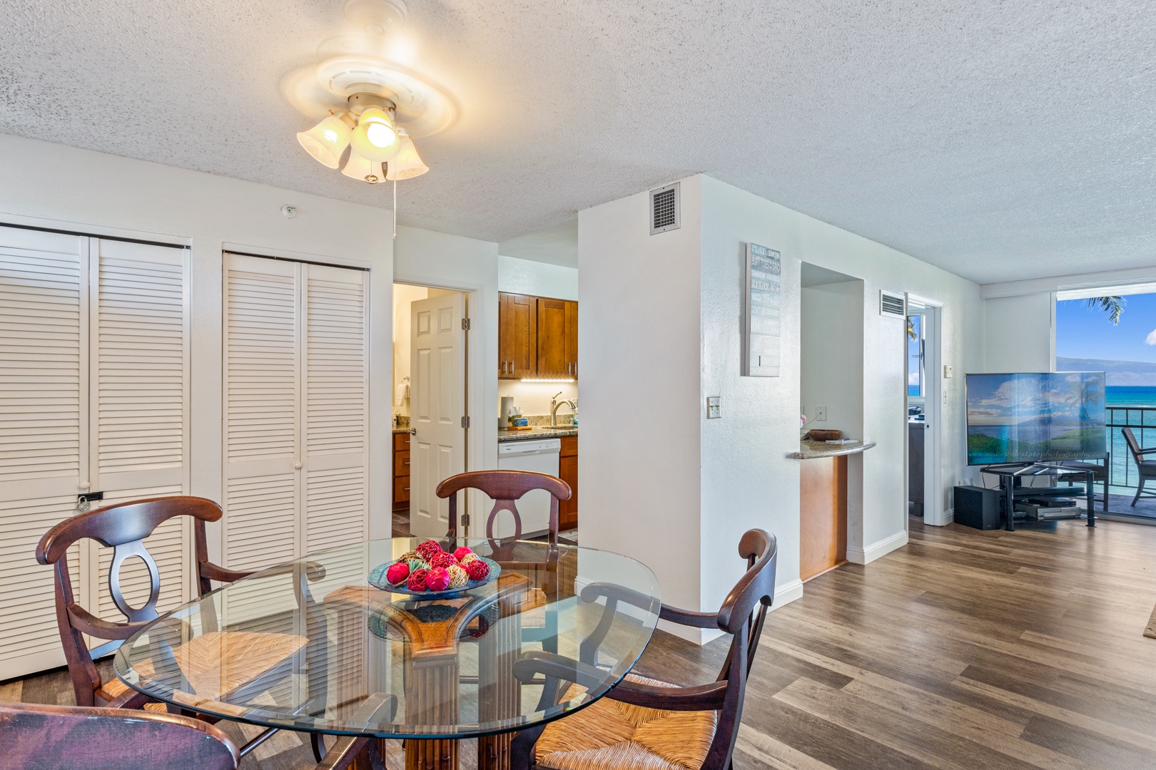 Lahaina Vacation Rentals, Royal Kahana 308 - A cozy dining area with a glass table and seating for four, located next to the kitchen for easy meal access.