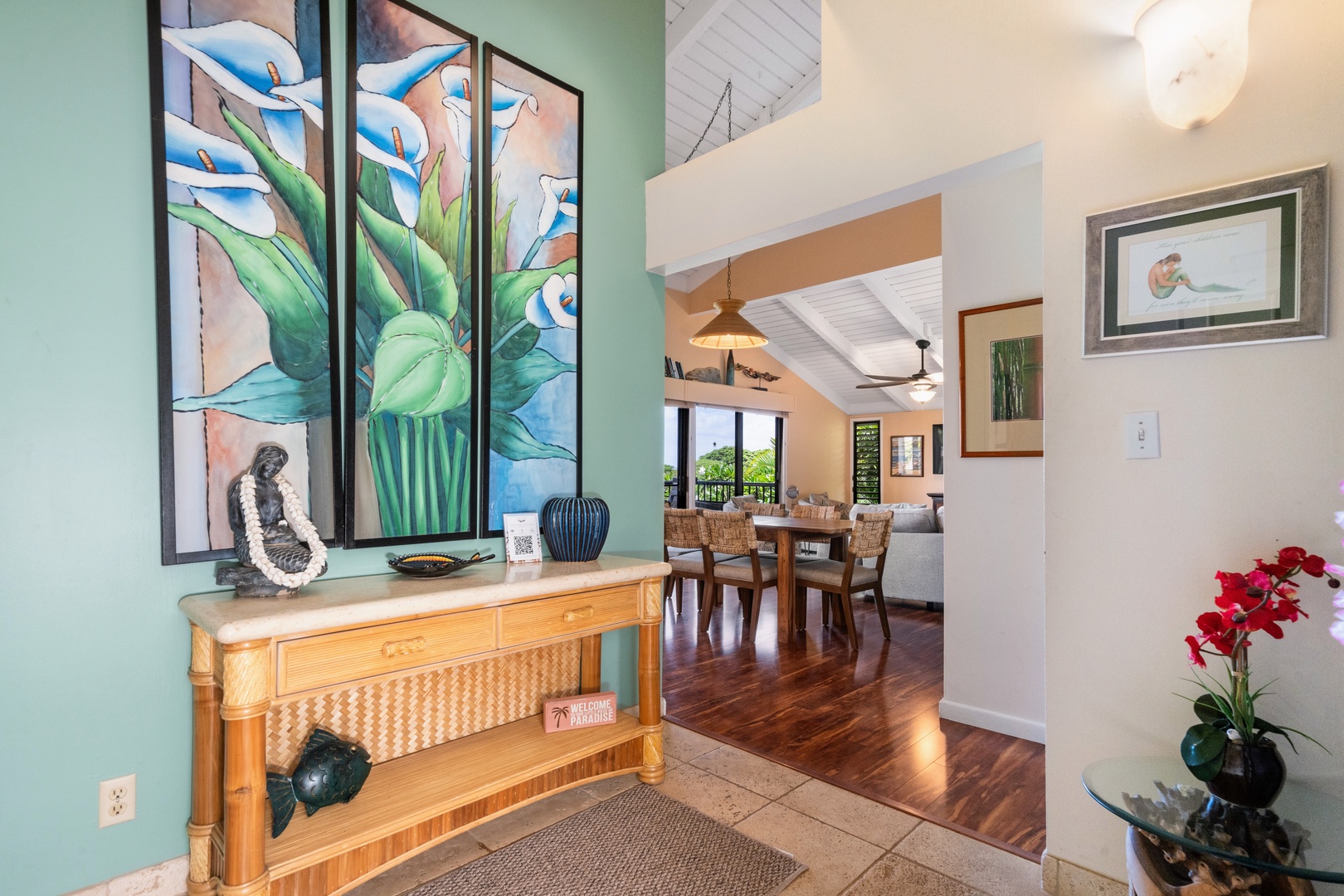 Kihei Vacation Rentals, Wailea Ekolu 204 - Step past the entry console and the vaulted living space opens straight ahead, ocean light catching the windows beyond the dining table.