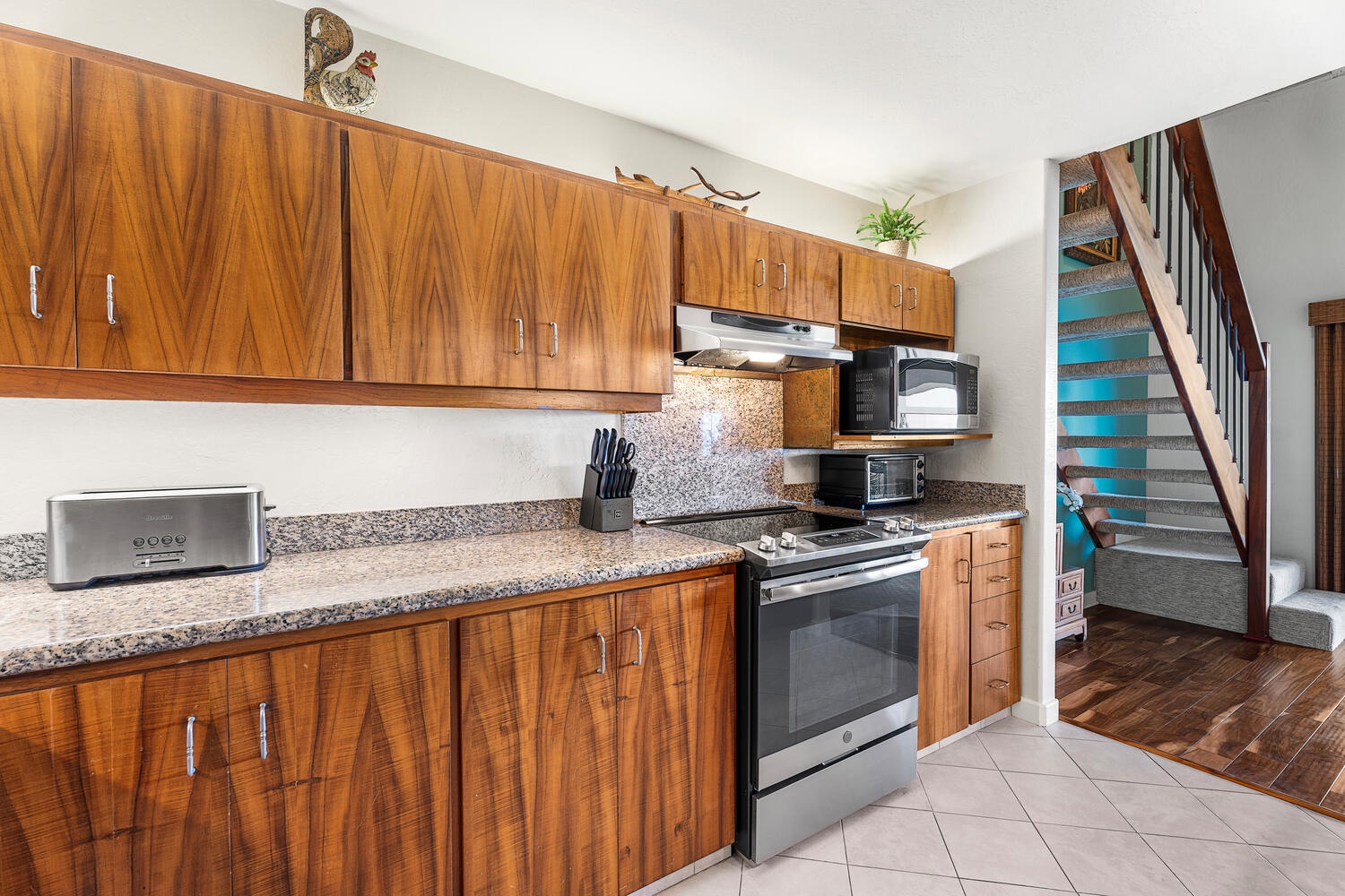 Kailua Kona Vacation Rentals, Kanaloa at Kona 3304 - Warm wood cabinetry and tile floors complete this functional and stylish kitchen.