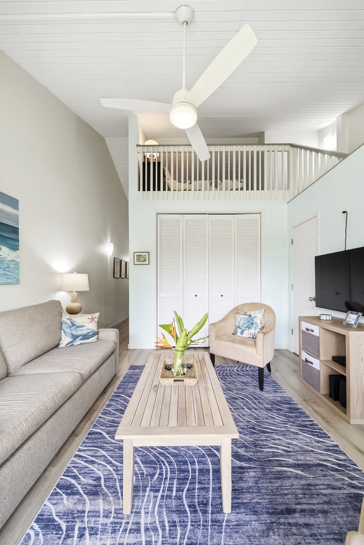 Kahuku Vacation Rentals, Kuilima Estates West #132 - The living area gathers around a low wooden table, framed by that ocean-blue rug.