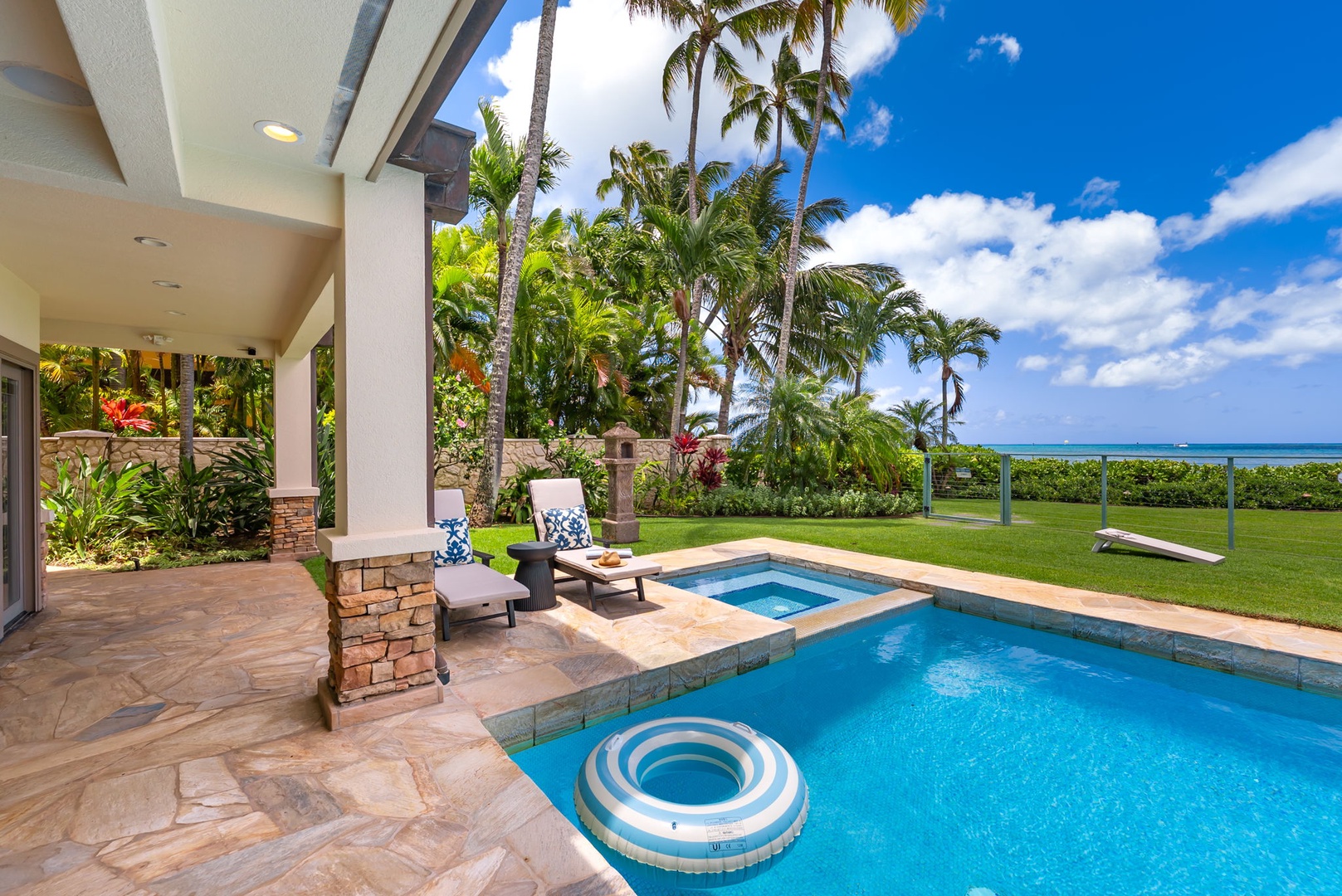Honolulu Vacation Rentals, Maunalua Estate - Relax beside the pool as tropical breezes and coastal views stretch beyond the palms.