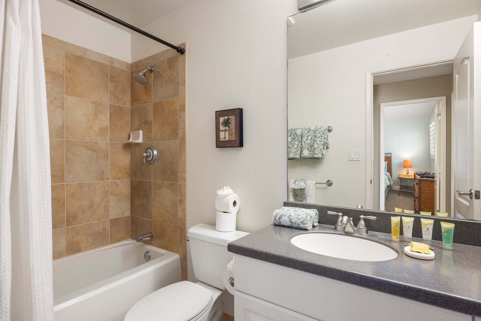 Refresh in your private bathroom featuring a shower-tub combo with elegant tile work and thoughtful amenities.