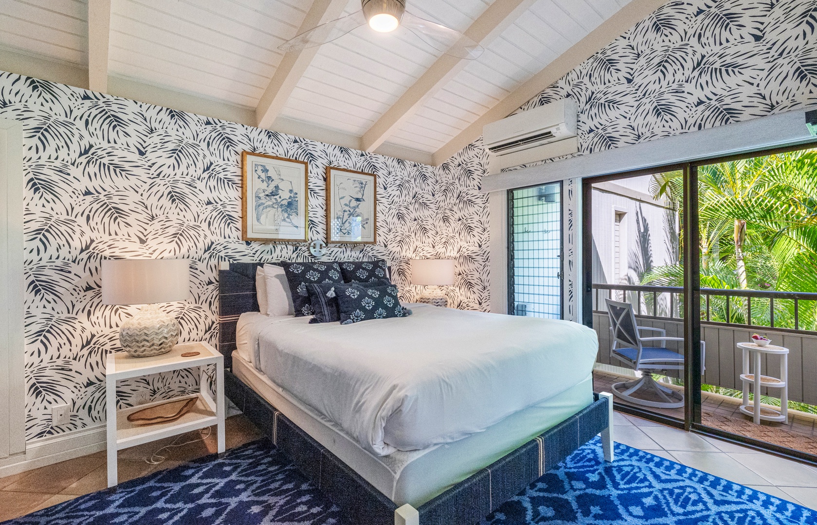 Kihei Vacation Rentals, Wailea Ekolu 1106 - The bedroom offers a cozy retreat with bold, tropical-inspired wallpaper and inviting natural light.