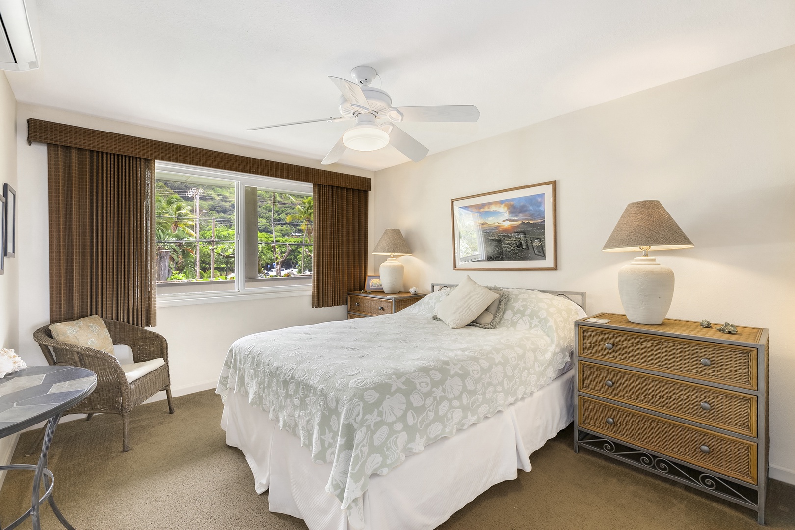Haleiwa Vacation Rentals, Hale Kimo - Guest bedroom two with a queen bed, fan and natural lighting.