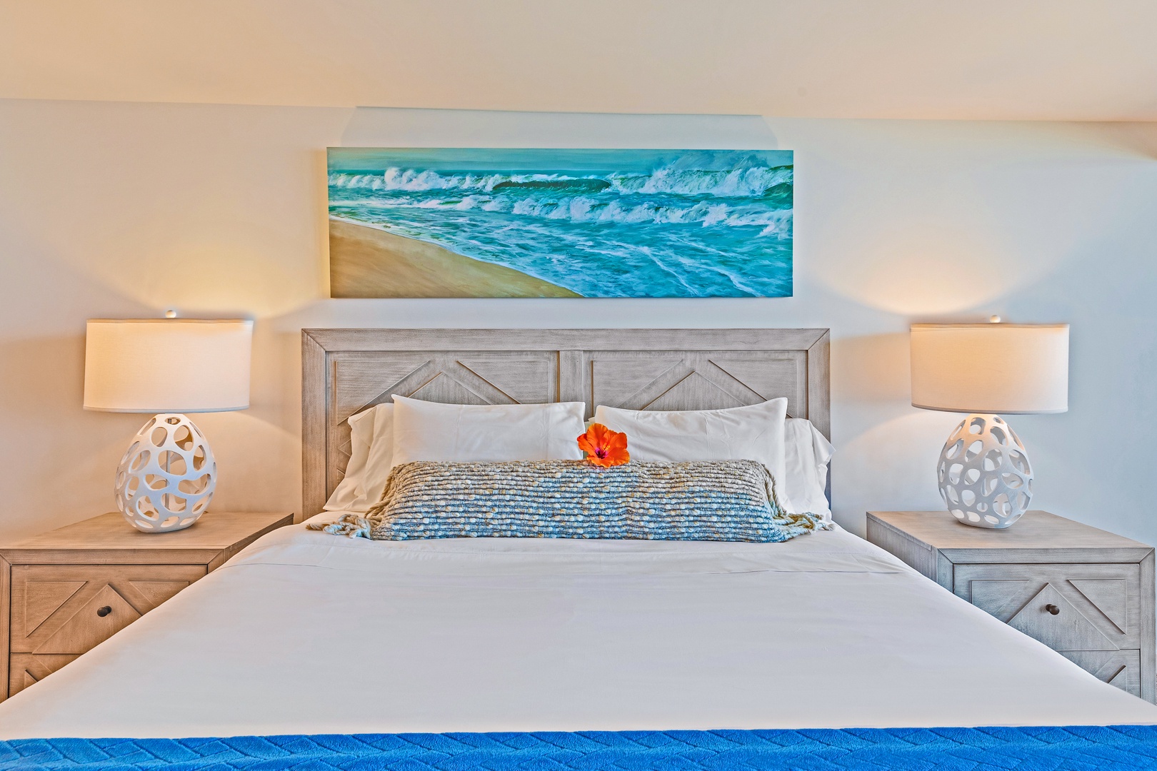 Lahaina Vacation Rentals, Kaanapali Shores 702 - The primary bedroom offers a comfortable king-sized bed with ocean-inspired artwork, creating a serene atmosphere for rest and relaxation.