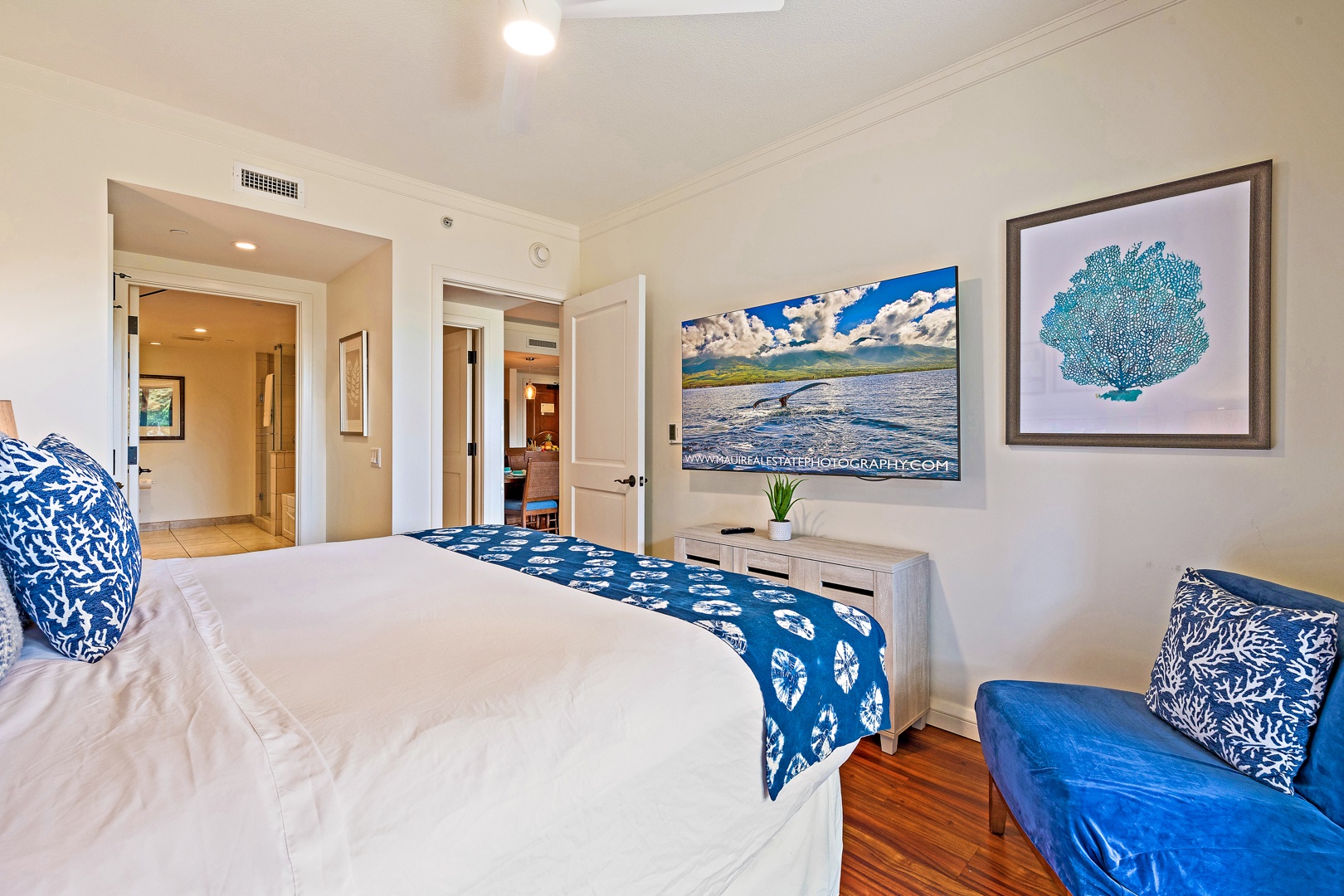 Lahaina Vacation Rentals, Honua Kai Konea 206 - The bedroom offers a relaxing space with a comfortable bed, vibrant artwork, and a flat-screen TV, perfect for unwinding after a day of exploring.