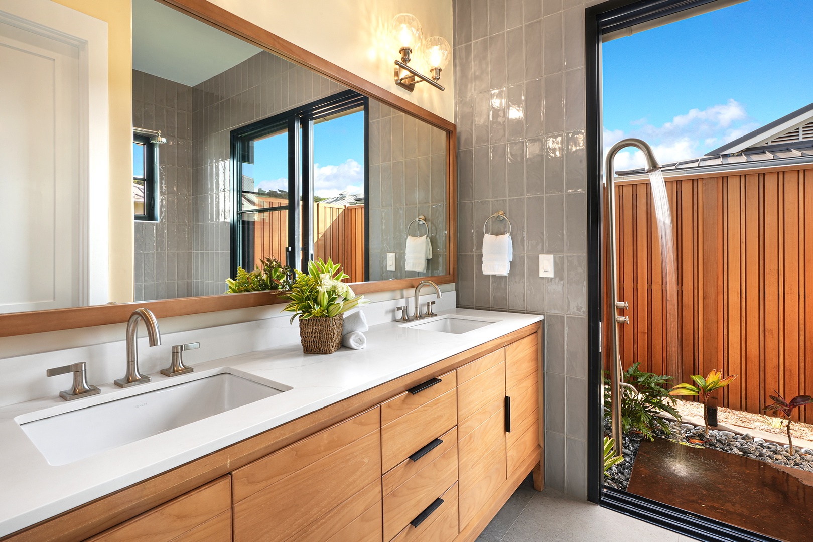 Koloa Vacation Rentals, Hali'a Mai - The ensuite bath opens to its own slice of sky, twin sinks set in warm wood.