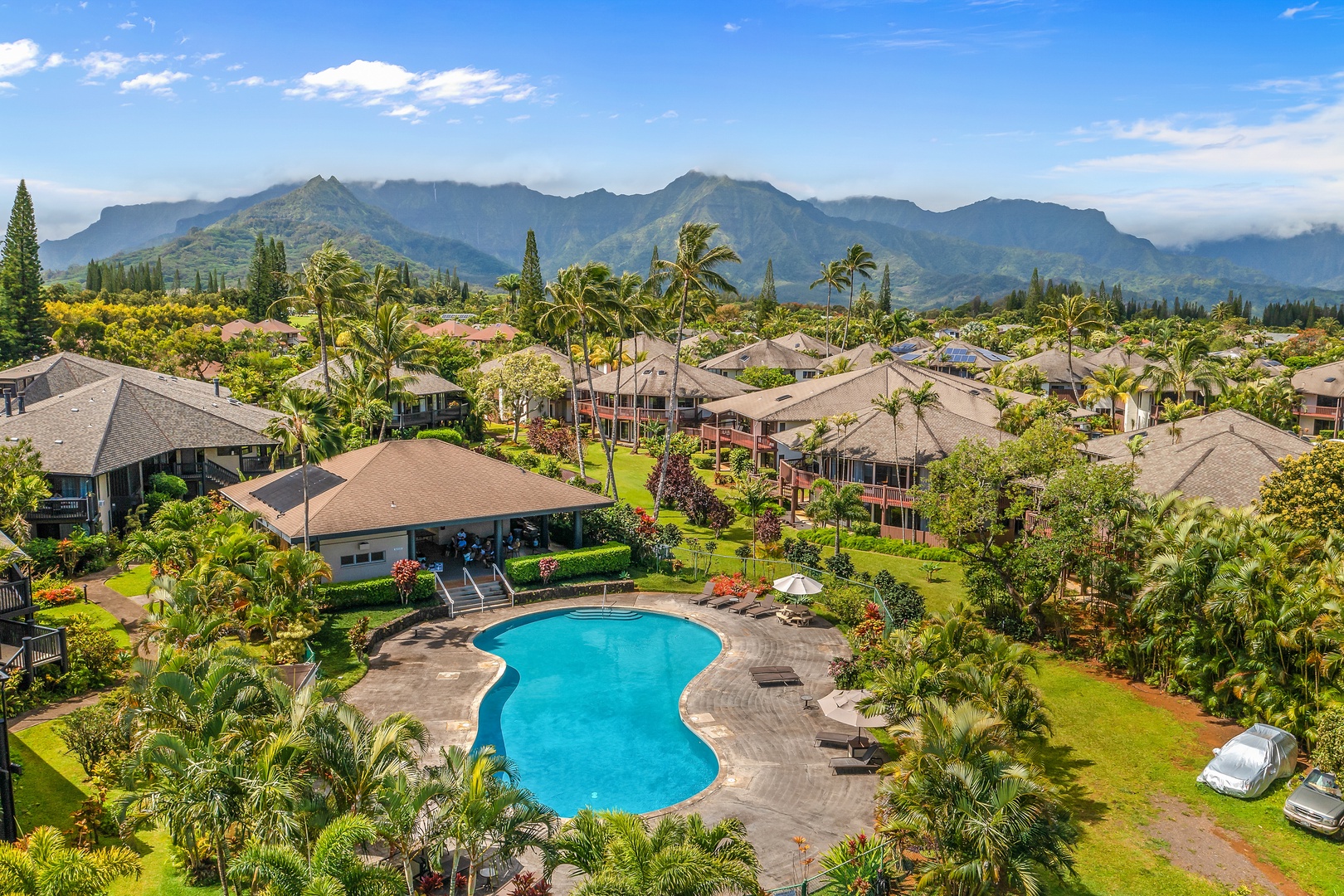 Princeville Vacation Rentals, Mauna Kai 7B - From above, the pool and gardens spread out below the North Shore mountains.