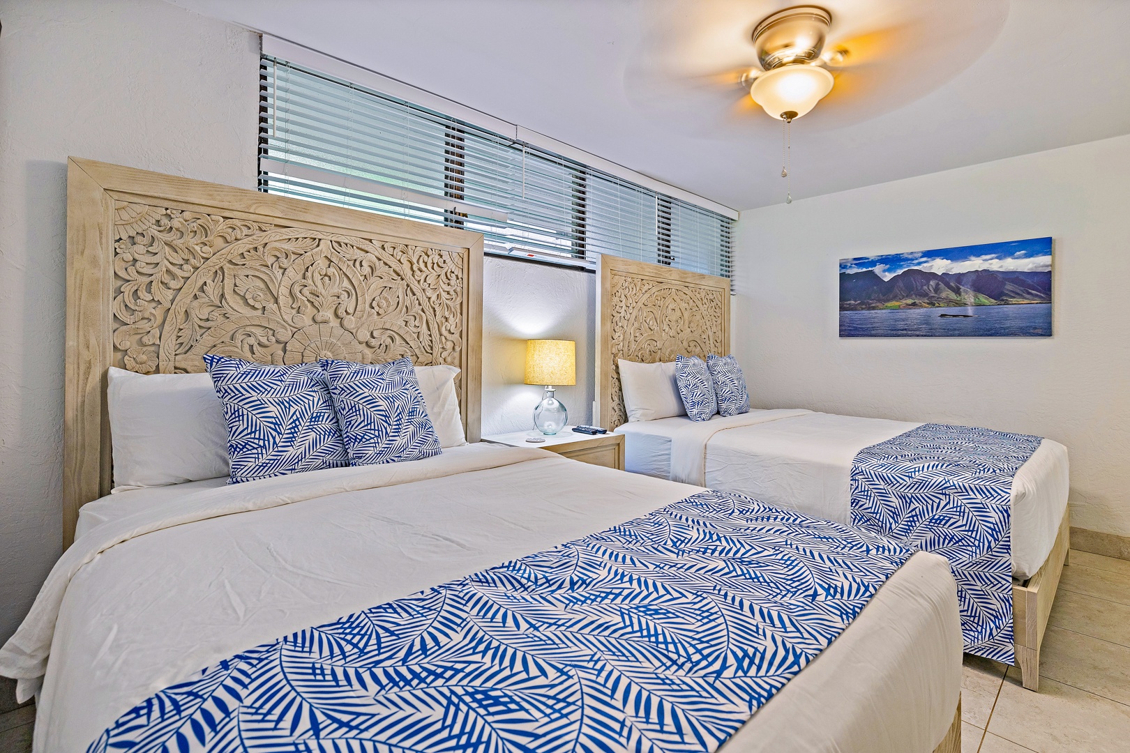 Lahaina Vacation Rentals, Papakea K-105 - The serene guest bedroom features two comfortable beds with tropical decor, offering a peaceful and relaxing retreat for family or friends.