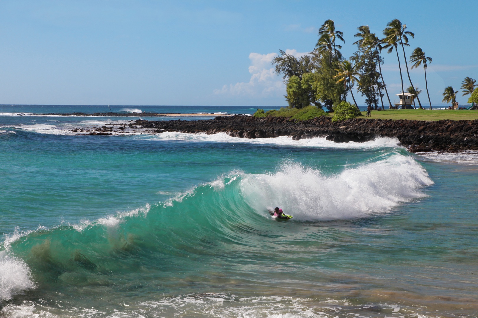 Koloa Vacation Rentals, Hiki Moe Hale - Watch skilled surfers ride the waves against a stunning backdrop at Kuhio Shores.