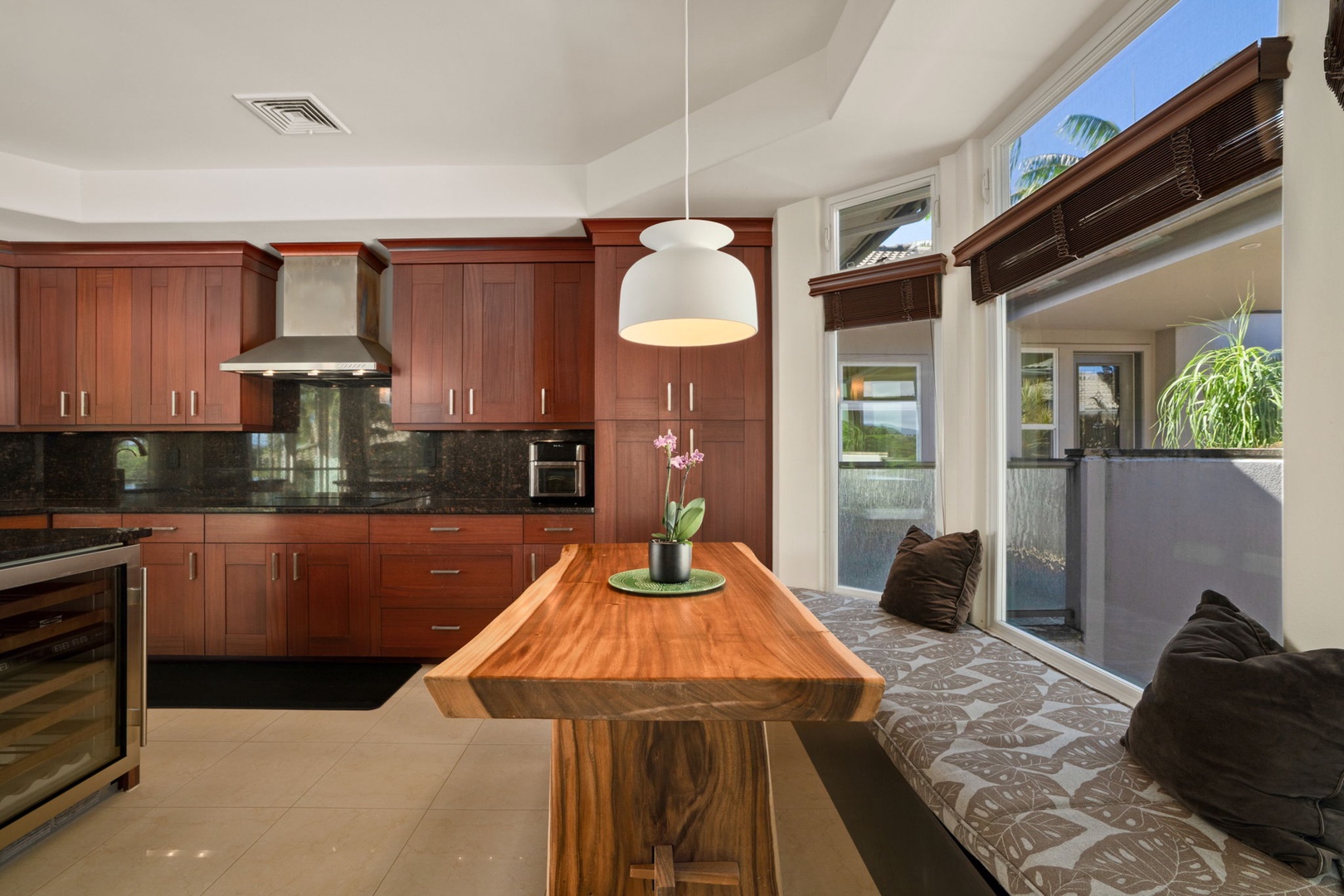 Princeville Vacation Rentals, Kaiulani #8 - Enjoy breakfast at the live-edge table, window bench cushions tucked close.
