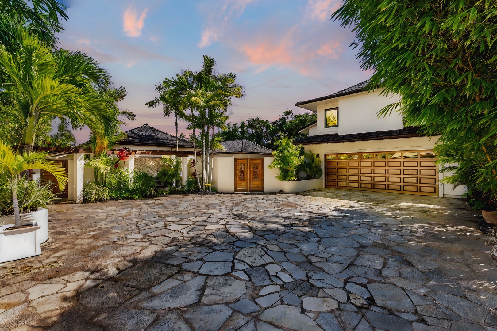 Honolulu Vacation Rentals, The Lagoon House 3BR - Stone driveway entrance lined with palms, arriving under soft sunset light.