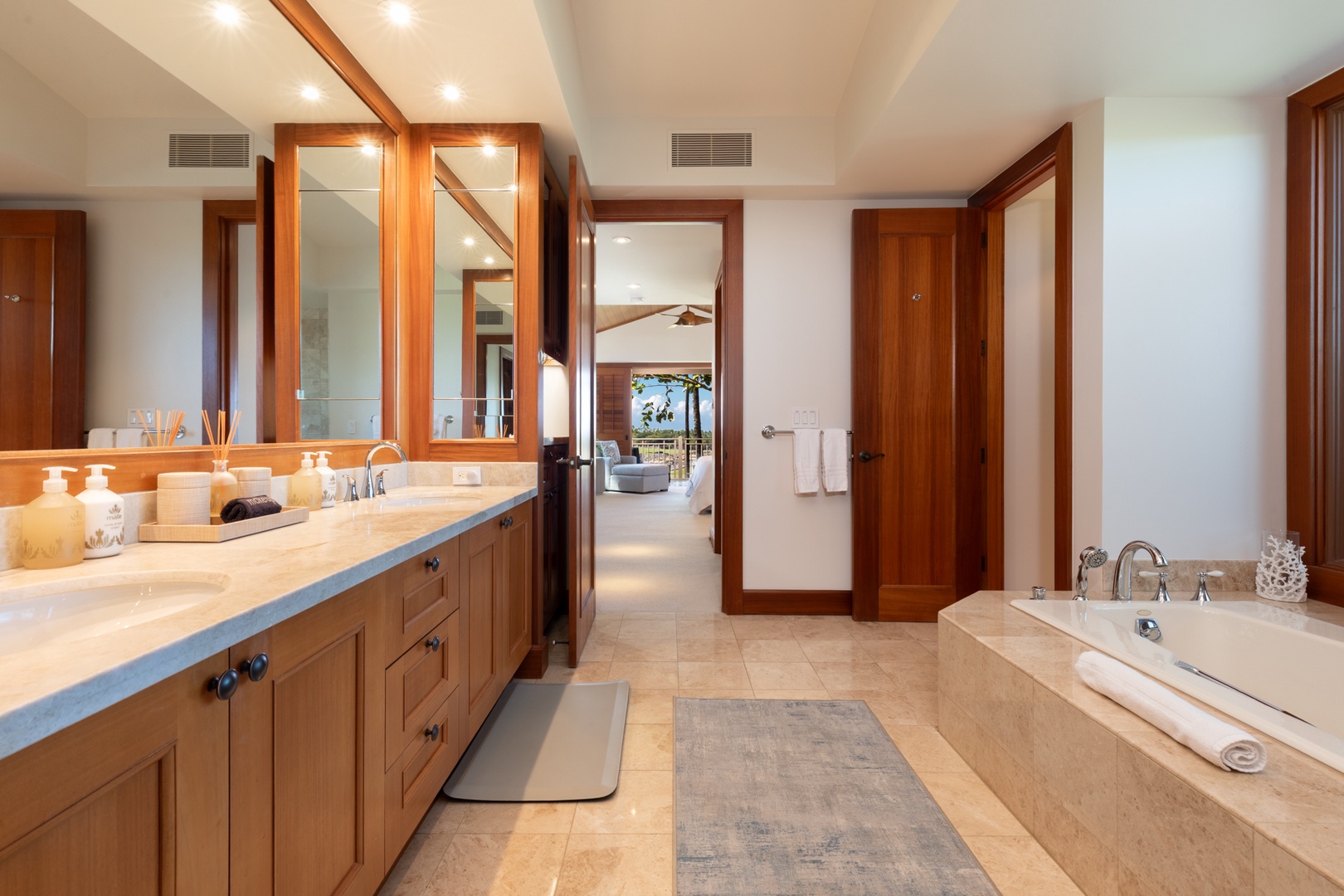 Kailua Kona Vacation Rentals, 3BD Waiulu Villa (111D) at Hualalai Resort - Luxurious bathroom with warm wood vanity, spa-style soaking tub, and premium amenities for your ultimate relaxation.