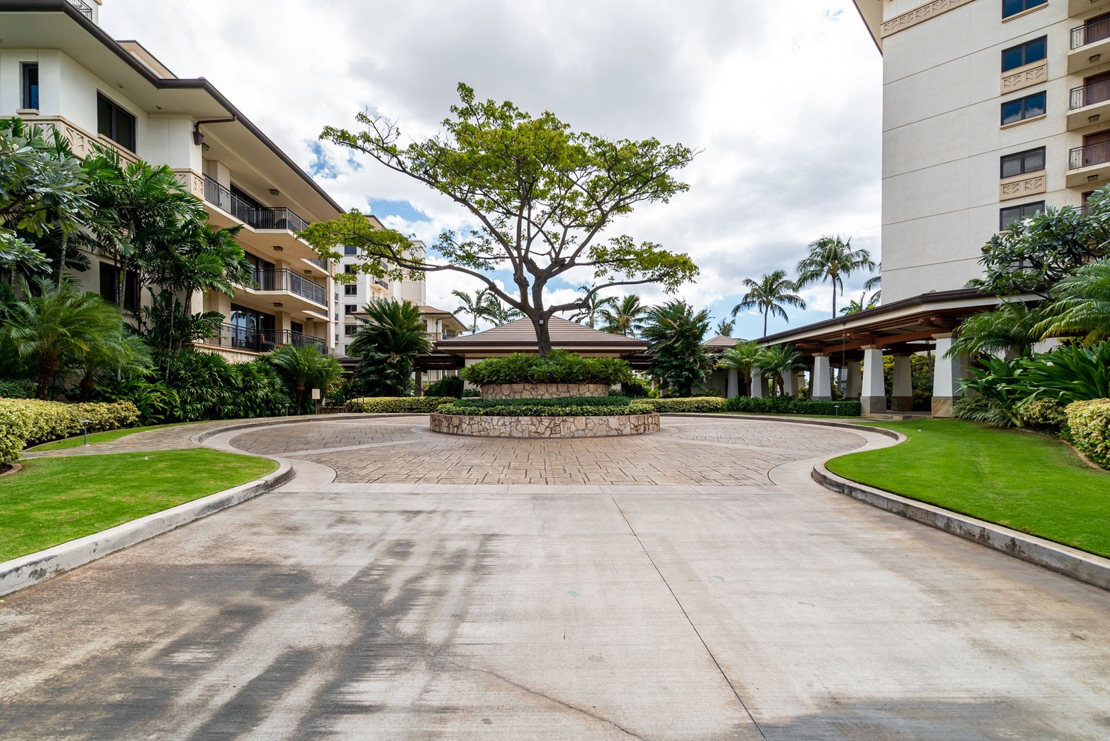 Kapolei Vacation Rentals, Ko Olina Beach Villas B604 - Elegant circular entrance courtyard with lush tropical landscaping and a distinctive central tree feature.