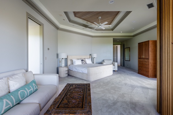 Kamuela Vacation Rentals, Canoe House & Beach Walker at Champion Ridge - Bright and airy primary bedroom with king-sized bed, cozy seating and a stylish ceiling design.