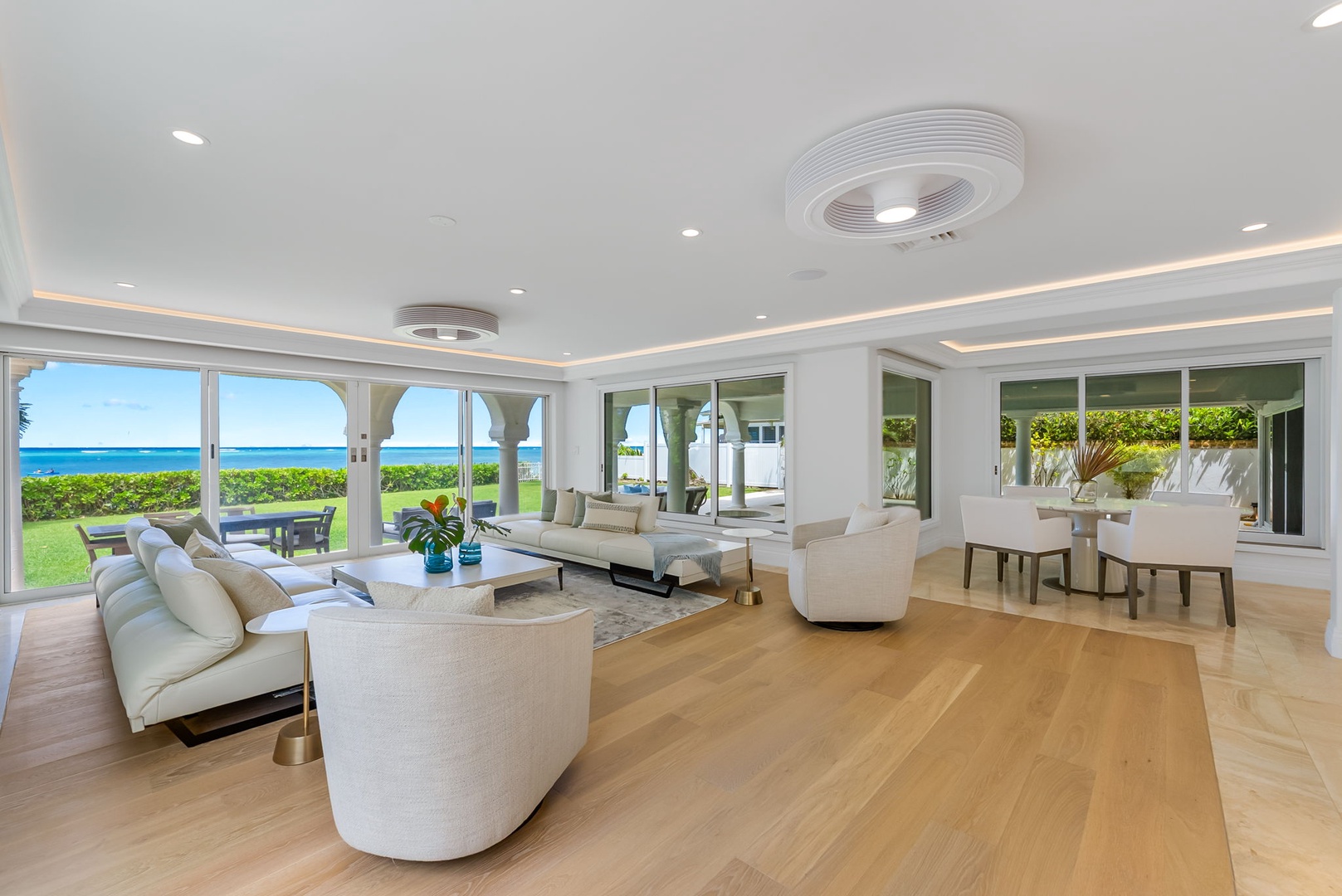 Kailua Vacation Rentals, Lanikai Sunrise Estate - Coastal-inspired living area offering ocean views, natural light, and ample space for relaxation or conversation.