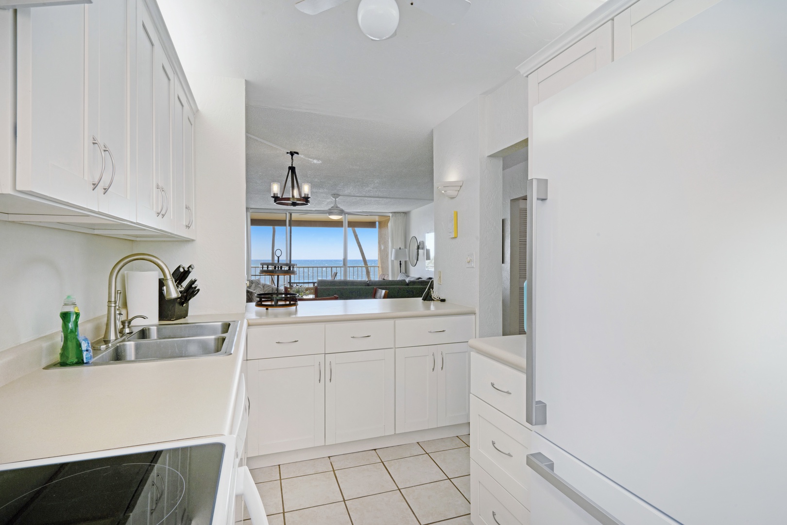 Kihei Vacation Rentals, Menehune Shores 316 - Open the fridge and the ocean's still visible over the pass-through counter.