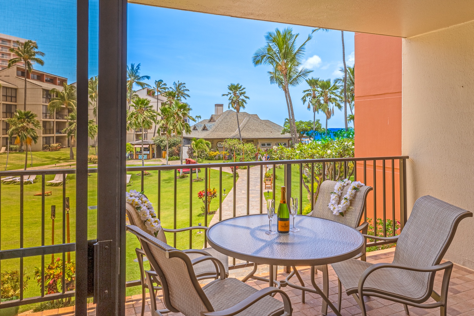 Lahaina Vacation Rentals, Kaanapali Shores 213 - Relax on the lanai with a refreshing drink and enjoy the view of the garden and ocean in the distance.