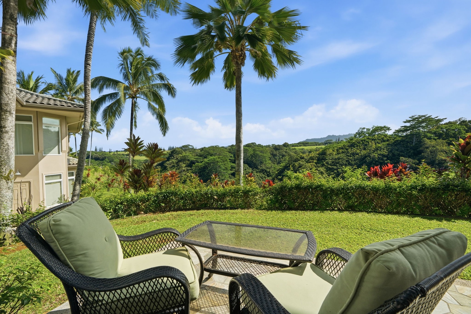 Princeville Vacation Rentals, Kaiulani #8 - Take the lanai chairs for a slow afternoon facing palms and valley views.