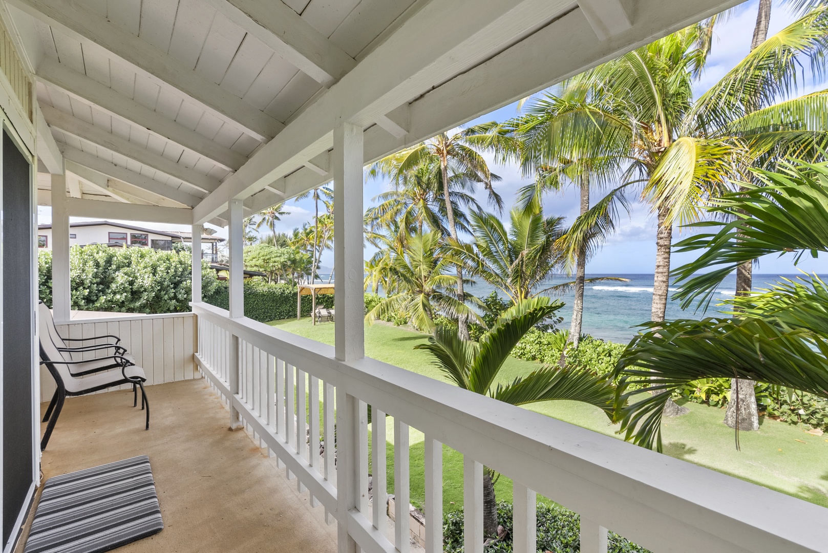 Haleiwa Vacation Rentals, North Shore Beachfront Retreat - Relax on the breezy lanai with views of swaying palms and the ocean.