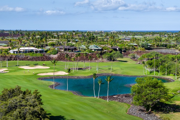 Kamuela Vacation Rentals, Canoe House & Beach Walker at Champion Ridge - Scenic view of a lush golf course with a tranquil pond, surrounded by tropical greenery