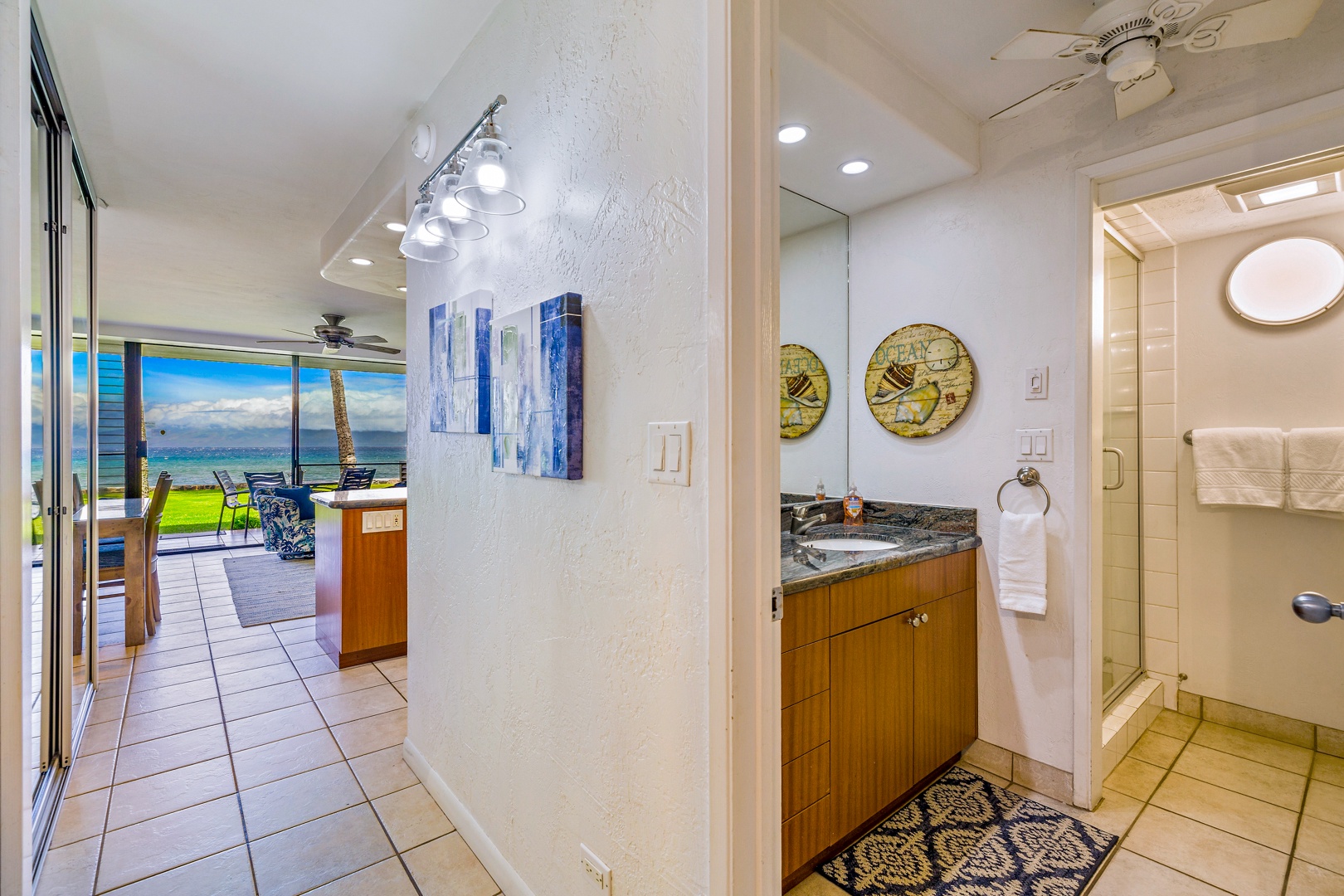 Lahaina Vacation Rentals, Papakea L-106 - This hallway bathroom, conveniently located near the living space, features a contemporary vanity and stylish decor