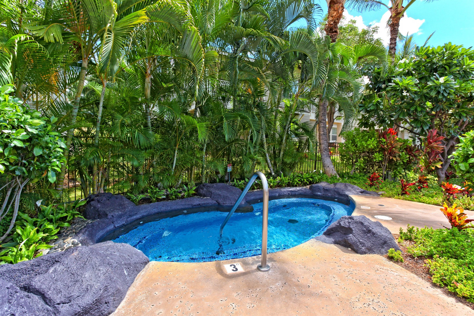 Kapolei Vacation Rentals, Ko Olina Kai 1097C - Outdoor hot tub with a handlebar, and palm trees in the background.