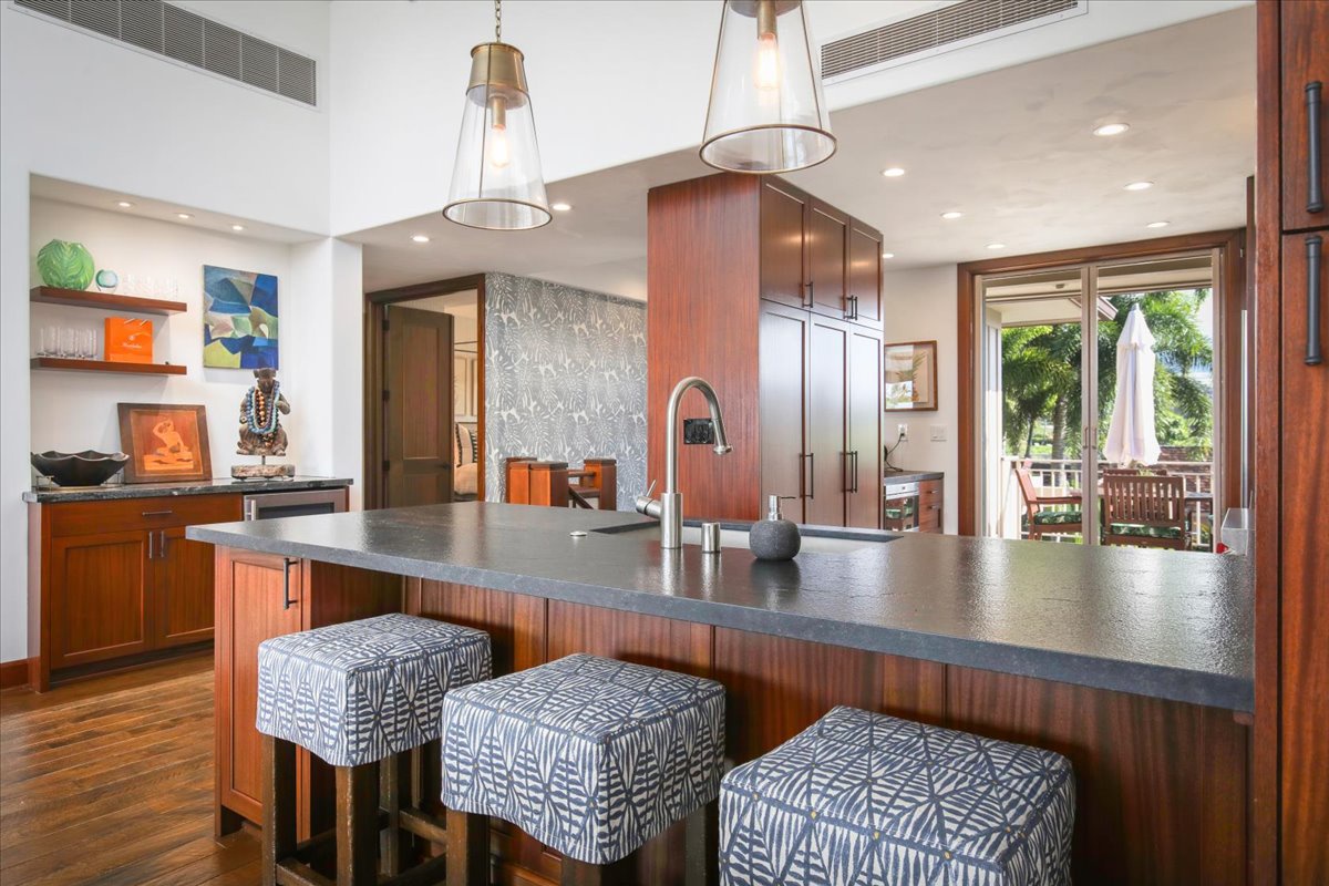 Kailua Kona Vacation Rentals, 3BD Ka'ulu Villa (129B) at Hualalai Resort - The kitchen bar has seating for three, perfect for quick meals and entertainment.