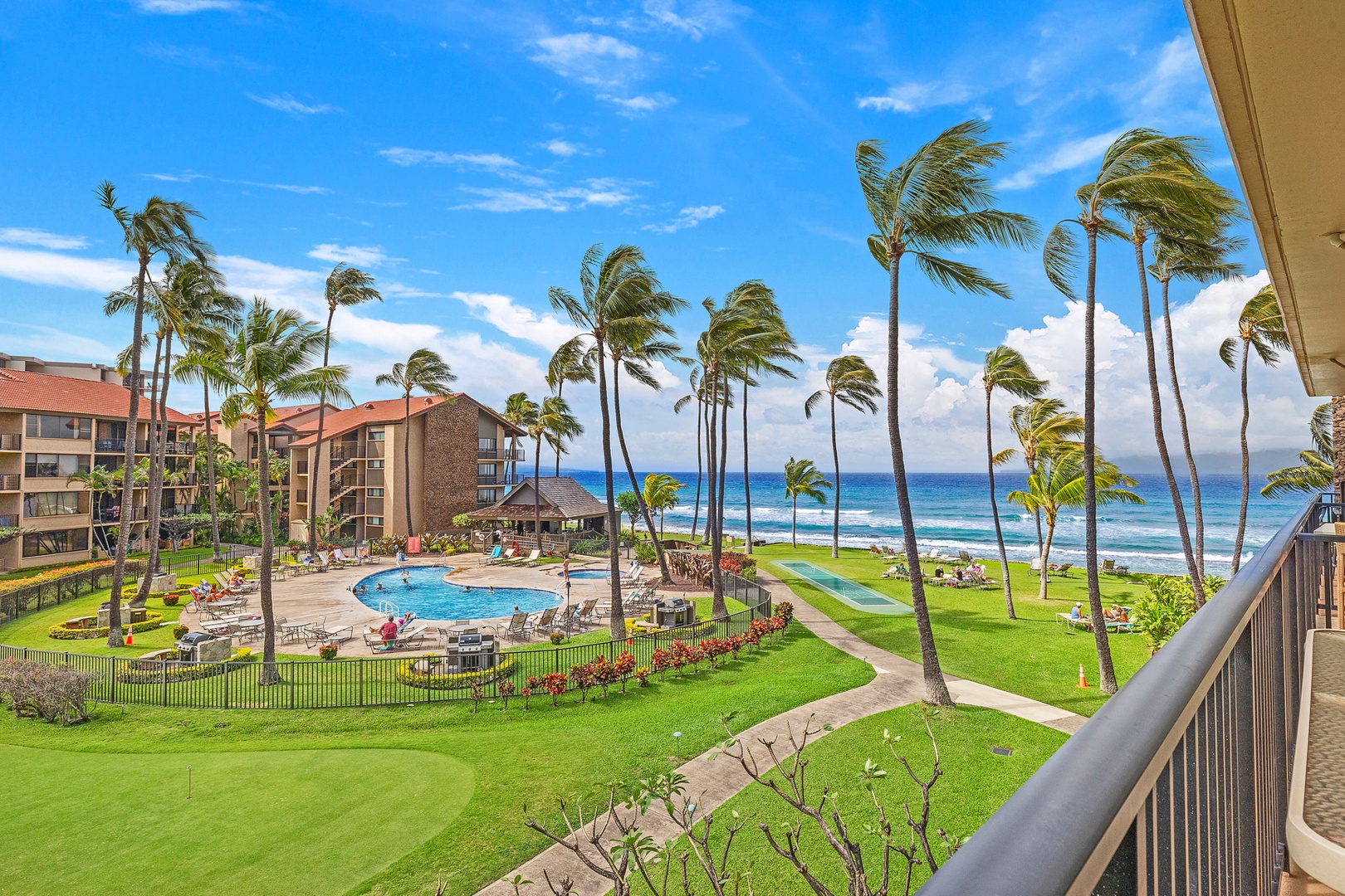 Lahaina Vacation Rentals, Papakea G-306 - The lanai offers breathtaking views of the resort's pool area and the stunning ocean, perfect for enjoying the tropical scenery and vibrant atmosphere.