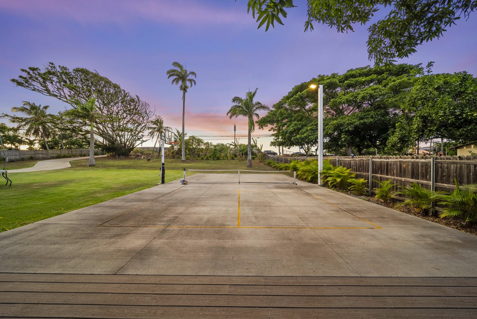 Haleiwa Vacation Rentals, Sunset Pickleball Paradise - Pickleball court surrounded by lush greenery provides a fun and energetic activity for guests to enjoy during their stay.