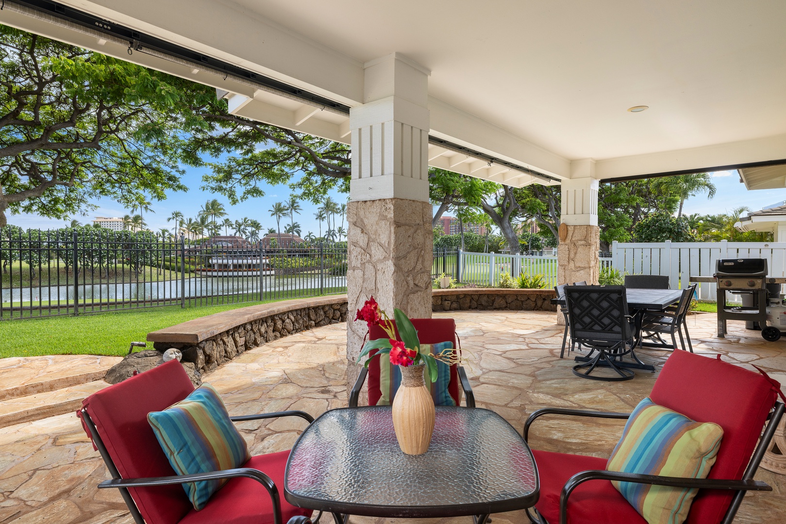 Relax on your private covered lanai with vibrant seating, tropical views, and dining space perfect for morning coffee or sunset cocktails.